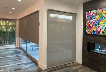 Long Beach living room featuring high quality custom sheer window shades fully closed on spacious sliding doors, enhancing privacy and style.