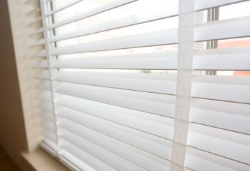 Faux wood blinds installed in a cozy living room