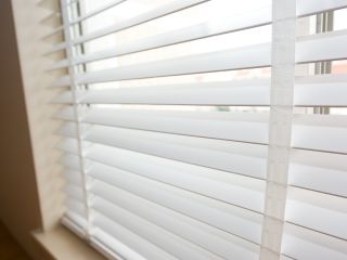 Faux wood blinds installed in a cozy living room